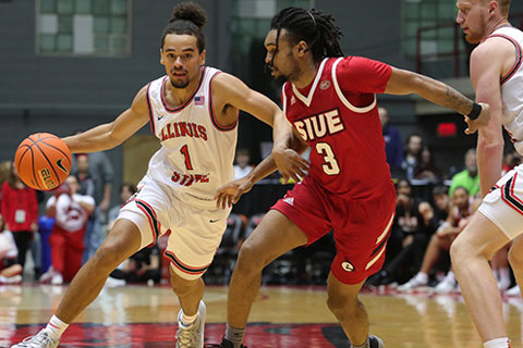 Basketball player defends the ball.